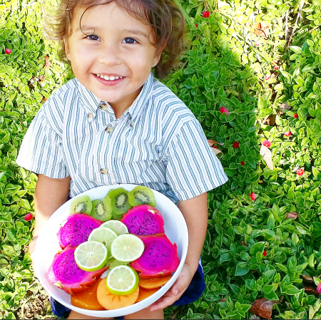 Bodhi holding mixed fruit